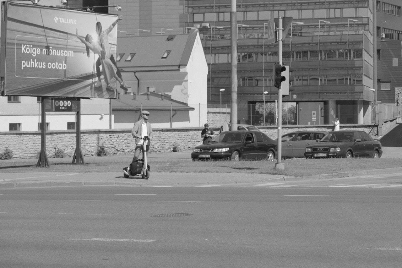 A man is riding an electric scooter.