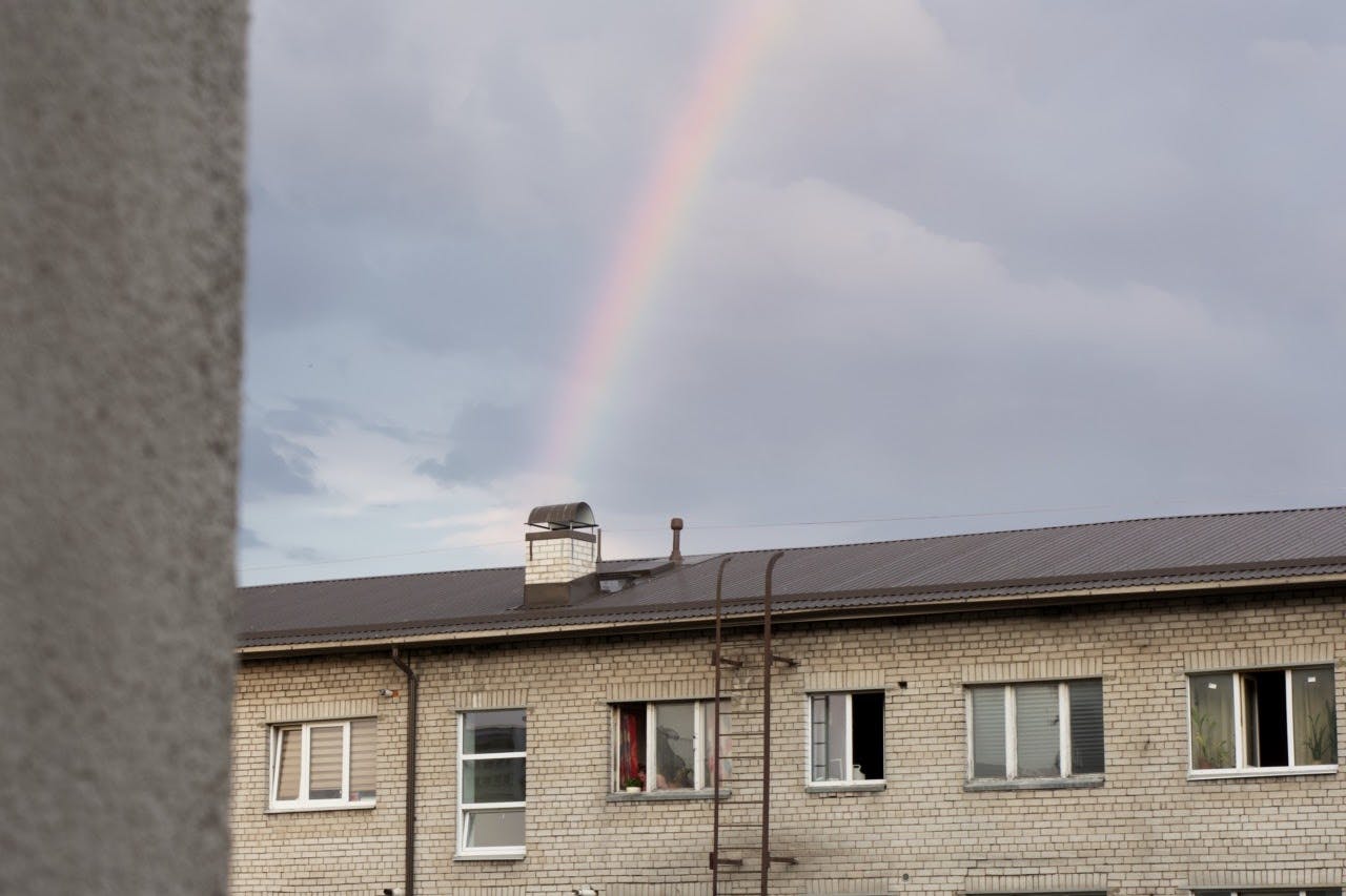 A rainbow after the rain in the heatwave week. As you can see, most people open their apartment window to cope with the hot temperature.